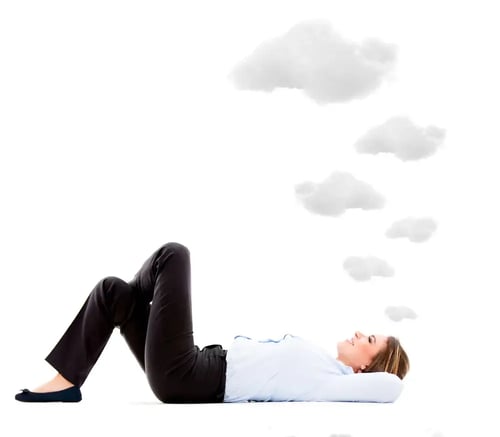 Business woman lying down daydreaming - isolated over white background