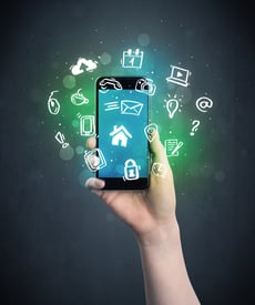 Caucasian hand in business suit holding a smartphone with drawn web icons