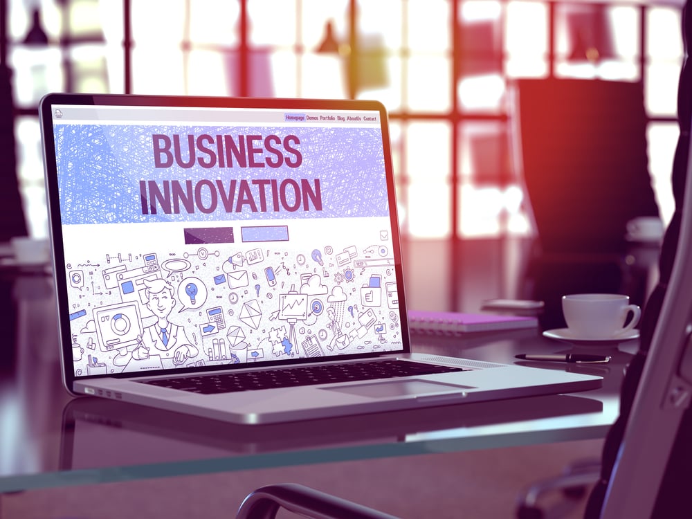 Modern Workplace with Laptop Showing Landing Page in Doodle Design Style with Text Business Innovation. Toned Image with Selective Focus. 3d Render.