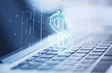 grafico signo de dolar sobre teclado alusivo a comisiones por venta de software