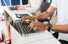 manos sobre teclado de laptop